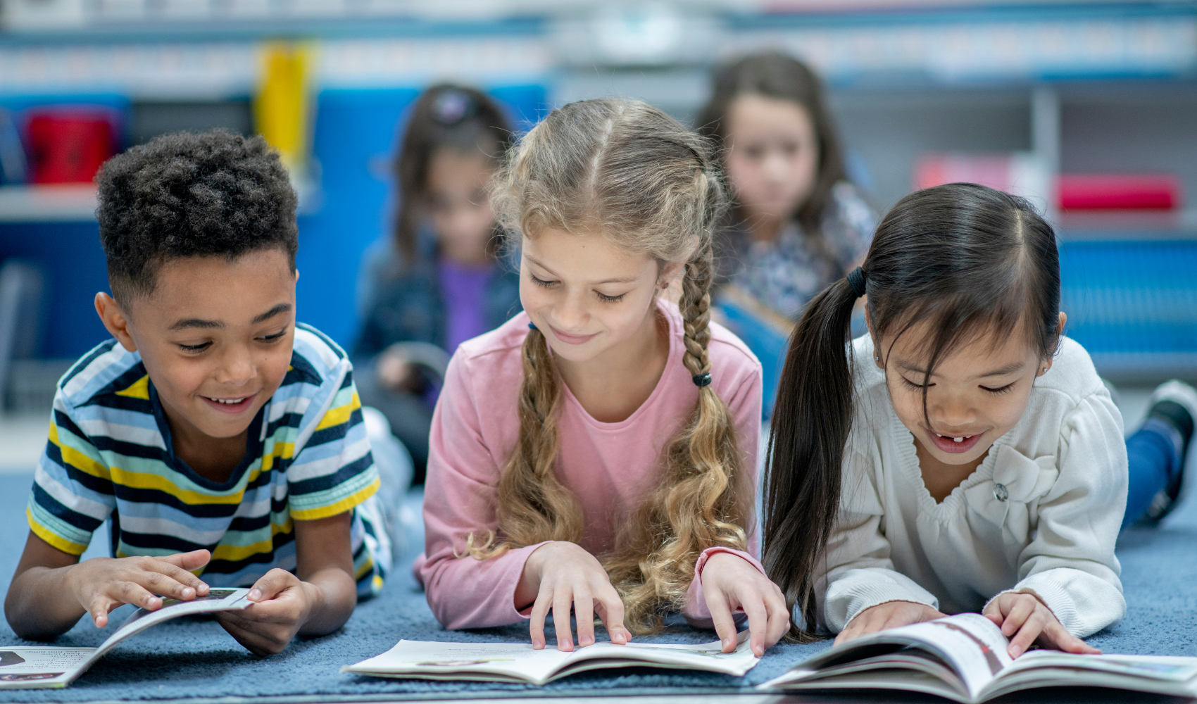 First graders reading together on the classroom rug
